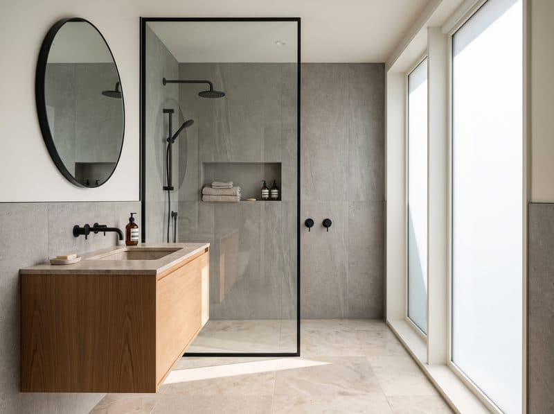 Newly fitted bathroom with tiled walls and a walk-in shower